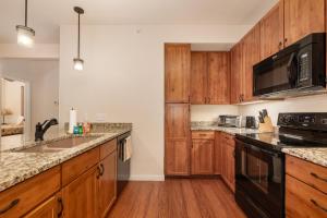 a kitchen with wooden cabinets and a black appliances at Ten Mile G201 in Granby