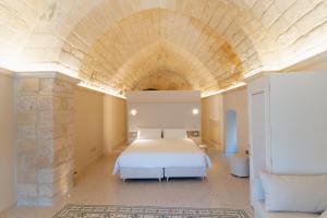 a bedroom with a bed in a large room at Palazzo Del Duca Hotel & Restaurant in Matera