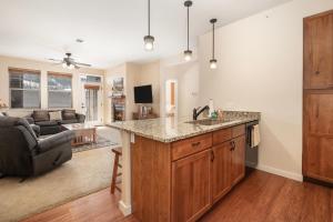 a kitchen with a sink and a living room at Ten Mile G201 in Granby