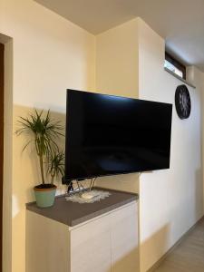 a flat screen tv hanging on a wall at La casa di Gio' Lake Maggiore Near Leonardo in Dormelletto