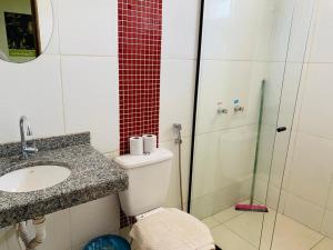 a bathroom with a toilet and a sink and a shower at Gaivota Hotel in Eldorado dos Carajás +23 photos