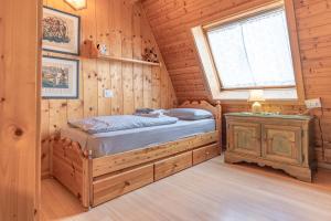 a bedroom with a bed and a window at Private Veranda - Tiroler Chalet - Near Ski Slopes & Dolomites in Carano