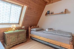 a bedroom with a twin bed and a window at Private Veranda - Tiroler Chalet - Near Ski Slopes & Dolomites in Carano