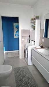 a bathroom with a washer and a washing machine in it at BlueCharme modern apartment in Quartu SantʼElena +31 photos