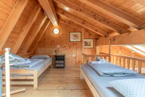 a bedroom with two beds in a wooden cabin at Private Veranda - Tiroler Chalet - Near Ski Slopes & Dolomites in Carano +19 photos