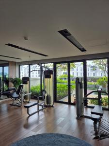 a room with a gym with chairs and windows at Swanbay - Rice's House in Nhơn Trạch