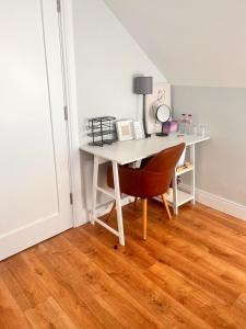 a white desk with a chair in a room at Drumquin Accommodation in Ennis