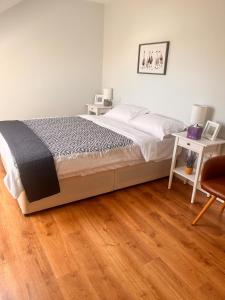 a bedroom with a bed and a desk and a chair at Drumquin Accommodation in Ennis