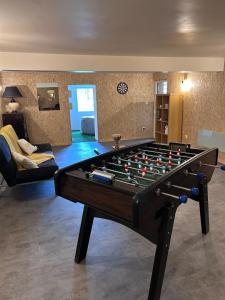 a living room with a large pool table at La Fabrique - Relaxing break with Jacuzzi in Crécy-en-Ponthieu