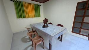 a table and chairs in a room with a window at Diws Holiday Bungalow in Anuradhapura
