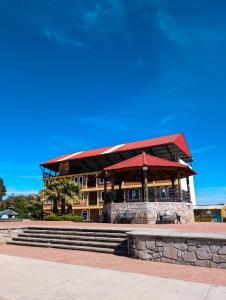 a building with a red roof and stairs in front at Hotel Bello Amanecer in Mineral del Chico