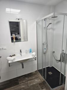a white bathroom with a sink and a shower at Alojamientos Santa Pola in Santa Pola