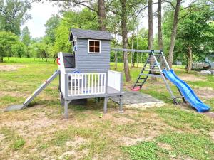 a playground with a slide and a play house at Attic rooms-Bēniņu istabas in Jelgava