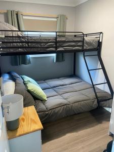 a bunk bed in a small room with a desk at 106 Cherry park in Chapel Saint Leonards