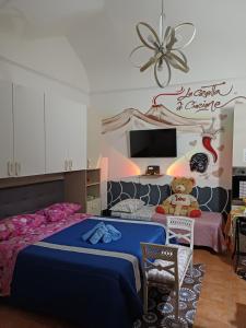 a bedroom with a bed and a teddy bear at la casetta di ciacione piazza del plebiscito in Naples