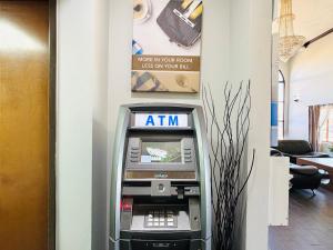 an atm machine sitting in a room next to a wall at Studio 6 Suites Elkhart, IN in Elkhart