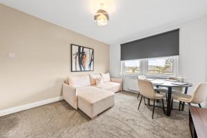 a living room with a couch and a table at Lesmahagow Hilltop View in Lesmahagow