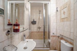 a bathroom with a shower and a toilet and a sink at Willa Karawela in Łeba +58 photos