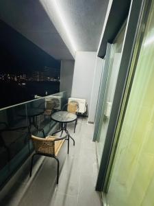 a room with a table and chairs on a balcony at Cloud 9 Bucharest Residence in Bucharest
