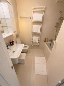 a bathroom with a sink and a toilet and a shower at Cloud 9 Bucharest Residence in Bucharest