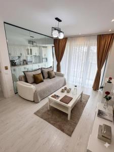 a living room with a couch and a table at Cloud 9 Bucharest Residence in Bucharest
