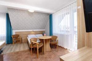 a dining room with a table and chairs at Willa Karawela in Łeba