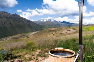 a wooden barrel sitting on top of a mountain at Pampachayoq - Mountain retreat in Urubamba