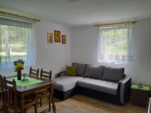 a living room with a couch and a table at Vikendica na Jazu in Kosjeric