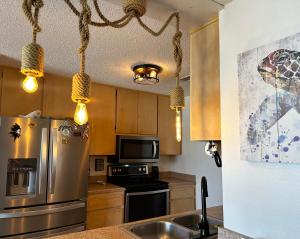 a kitchen with a stainless steel refrigerator and a microwave at Pura Vida in Navarre