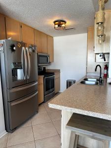 a kitchen with a stainless steel refrigerator and a sink at Pura Vida in Navarre +17 photos