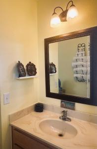 a bathroom with a sink and a mirror and towels at Pura Vida in Navarre