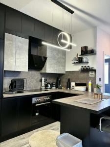 a kitchen with black cabinets and a black counter top at Guest House Eden in Bihać
