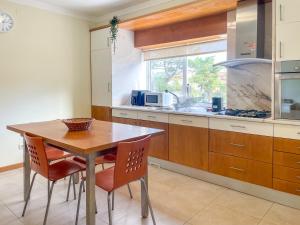 a kitchen with a wooden table and chairs at Cozy & Calm Beach House in Ovar