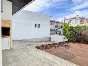 a white building with a courtyard in front at Cozy & Calm Beach House in Ovar