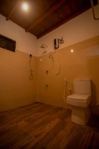 a bathroom with a toilet and a shower at Rainforest Hide View in Deniyaya