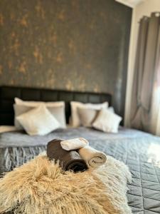 a teddy bear laying on top of a bed at Guest House Eden in Bihać