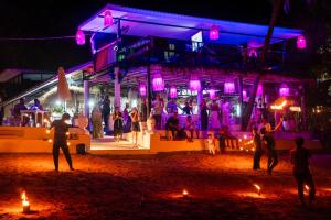 a group of people standing outside of a nightclub at night at Bungalow - Sleeps 2 - Terrace - Beach Close in Ko Lanta