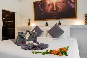 a bedroom with two stuffed animals on a bed at Bungalow - Sleeps 2 - Terrace - Beach Close in Ko Lanta