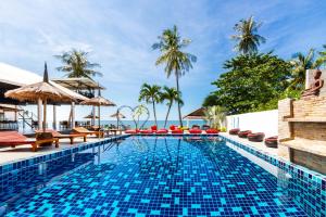 a swimming pool at a resort with palm trees at Bungalow - Sleeps 2 - Terrace - Beach Close in Ko Lanta