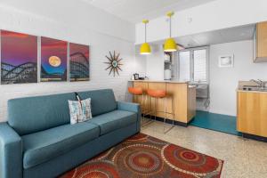 a living room with a blue couch and a kitchen at The StarLux in Wildwood