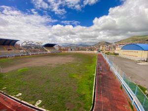 an empty field next to a soccer stadium at Nayras Puno Hotel in Puno