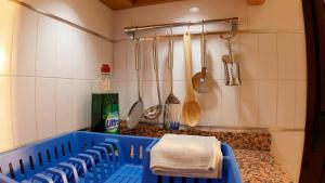 a kitchen with blue chairs and utensils on the counter at Apartalux San Pedro Playa in San Pedro del Pinatar