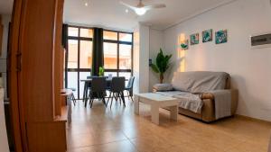a living room with a couch and a table at Apartalux San Pedro Playa in San Pedro del Pinatar +17 photos