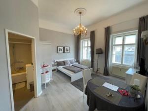a living room with a couch and a table in it at SEEPERLE am See in Gmunden