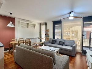 a living room with two couches and a table at Terraza Varellas in Latas