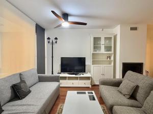 a living room with a couch and a flat screen tv at Terraza Varellas in Latas