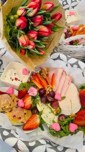 a plate of food with fruits and vegetables and strawberries at DOMKI LAURA sauna & gorąca balia in Jastrzębia Góra