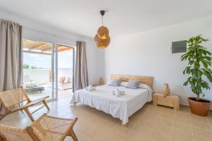 a bedroom with a bed and a potted plant at Villa Conguitosby 3VILLAS in Sant Lluis