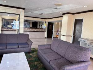 a living room with a couch and a table at Super 8 by Wyndham Corpus Christi in Corpus Christi