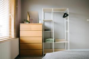 a bedroom with a dresser and a mirror at Central Dundee, 1 Bed, Parking, 3 Nights in Dundee